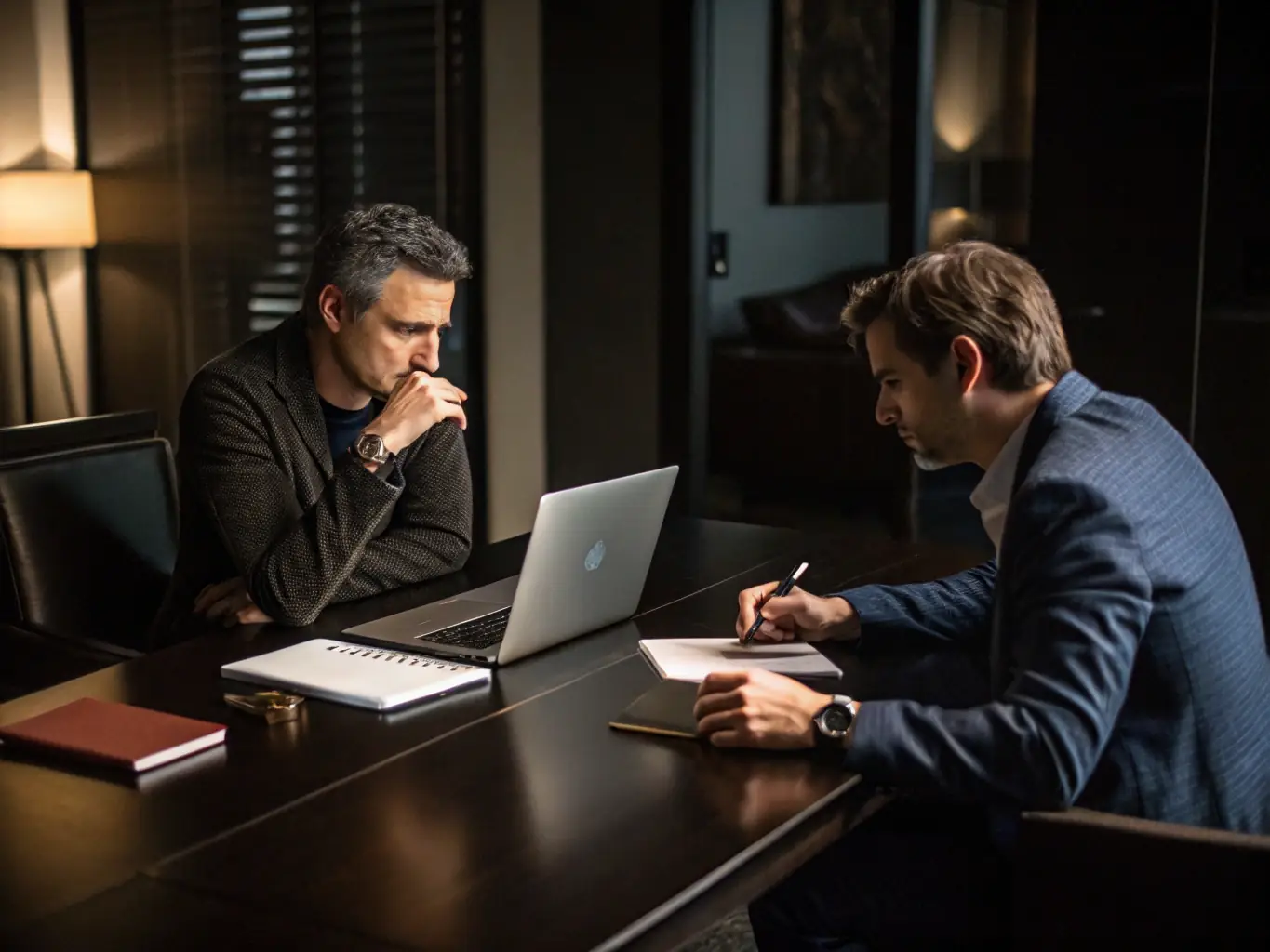 A professional consultant is advising a new business owner on the different types of company structures available, with documents and a tablet displaying registration forms on the table.